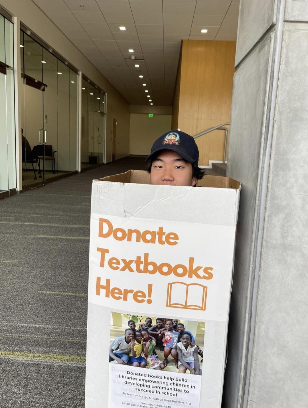 James Seo sits in a Campus Donations box ready to surprise UVU Students